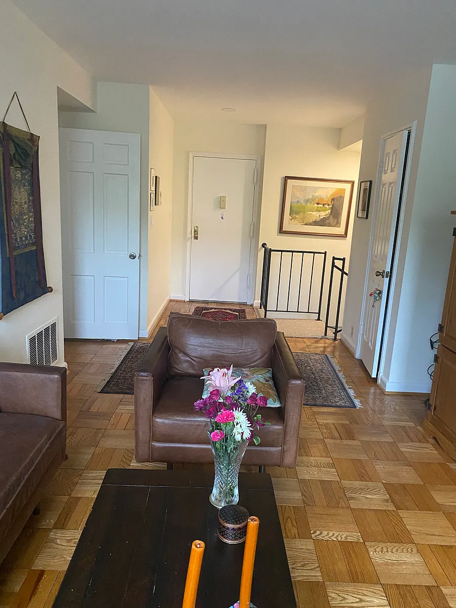 Main entrance on upper level with view of stairway to lower level and entrance to the bathroom and the bedroom on the left. There is coat closet on the right. - 3872 Porter St NW #A355