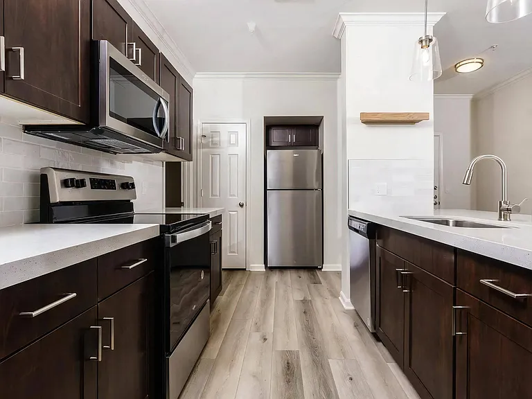 Modern Apartment Kitchen with Stainless Steel Appliances and Ample Storage