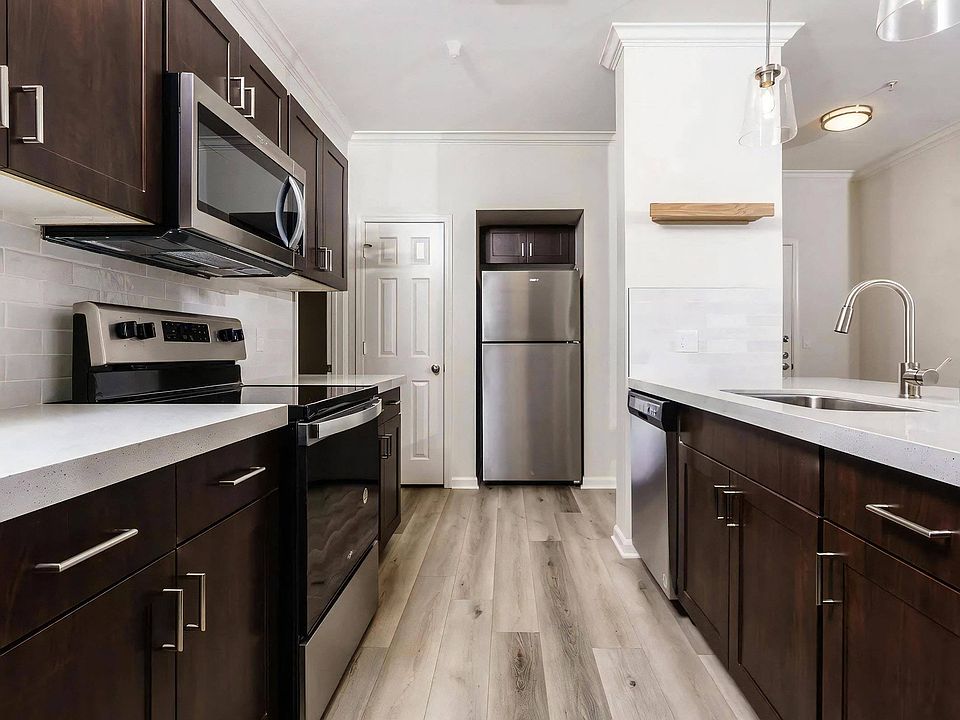Modern Apartment Kitchen with Stainless Steel Appliances and Ample Storage
