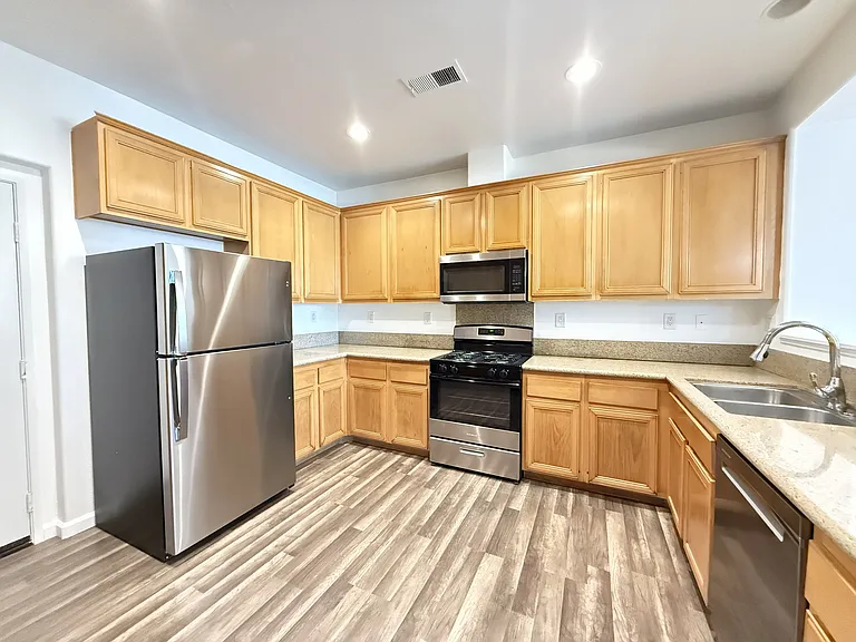 Spacious kitchen with brand new fridge and dishwasher
