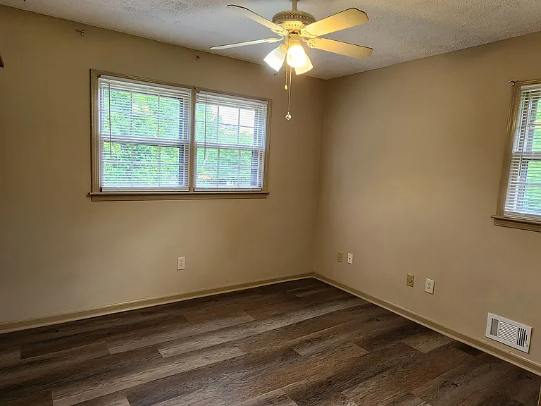 Bedroom one with double-door closet and ceiling fan. Bedroom two is a similar size, also with a double-door closet and ceiling fan.