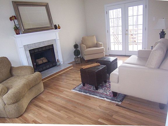 Living Room with Fireplace, Brand New Wood Floors, and New French Door to Deck