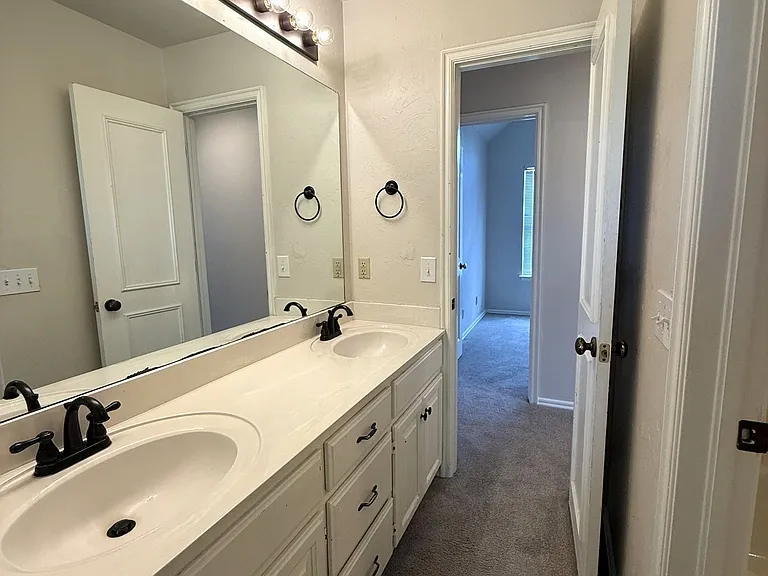 This is the jack-n-jill bathroom upstairs between bedroom 2 and the hall. Across the hall is bedroom 3. Double vanity in the upstairs bathroom. On the right is the private shower/tub combo and toilet with it's own private door.