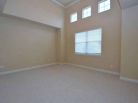 17x12. Master bedroom with high ceiling, crown molding. Extra high windows bring natural light.