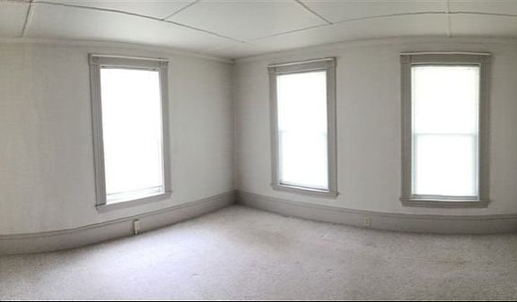 This cheery bedroom has ample light coming from three large windows as well as two closets!