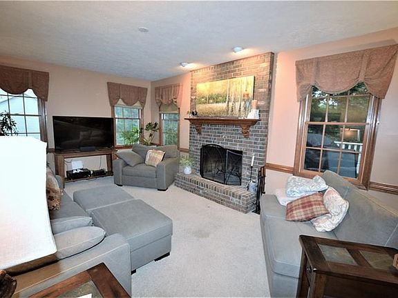 Family room with brick, floor-to-ceiling Fireplace