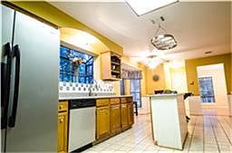 Beautiful galley kitchen with new granite, picture box window and updated appliances. Kitchen has al