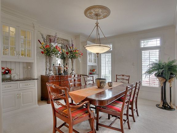 Formal Dining Room with built in shelves, plantation shutters!