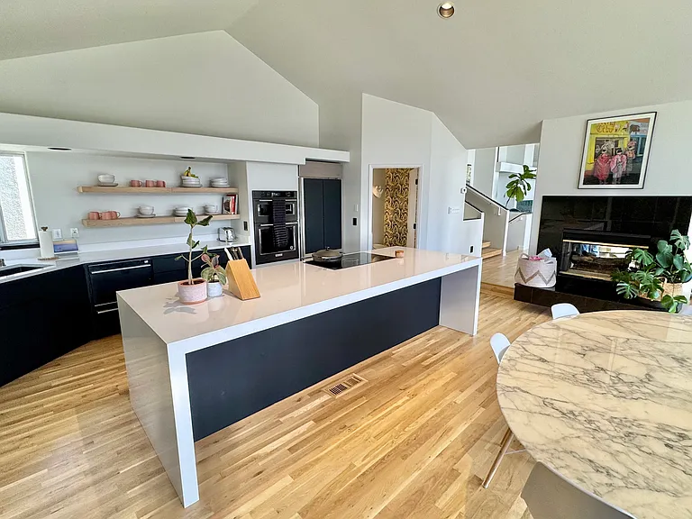 Kitchen/Dining room with 96" Knoll Sarinaan table and Eames dining chairs.