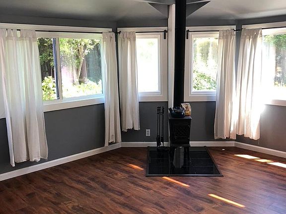 4yo flooring, lots of windows. Wood burning stove can be used as an additional heat source.