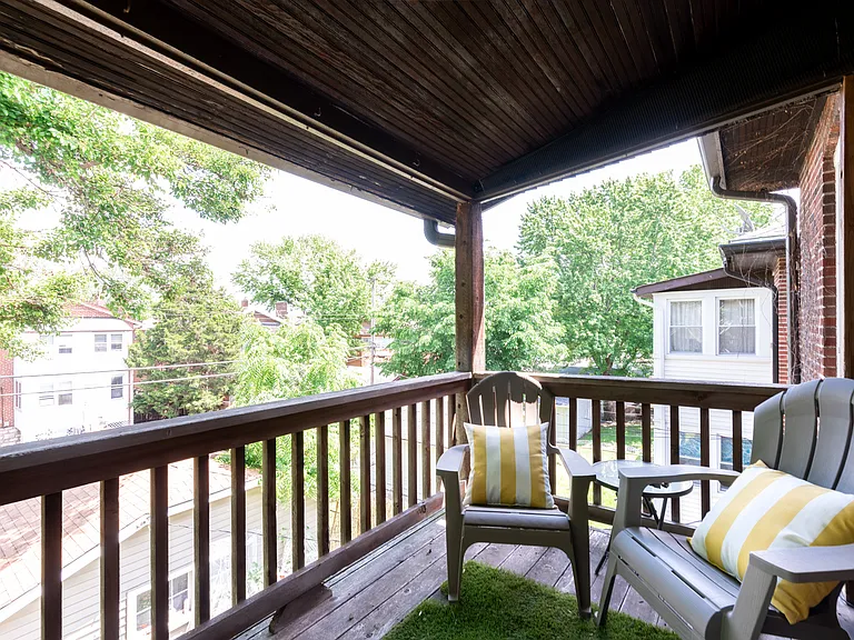 Covered Rear balcony with space for chairs and a small table