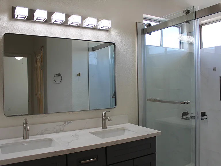 updated vanity and lights in primary bathroom