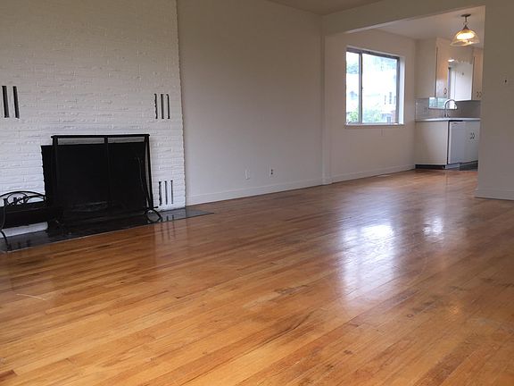 Lving room with wood burning fireplace and oak floors.