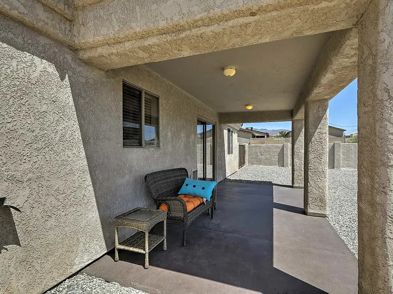 Back patio. Backyard is large and fenced with wall.