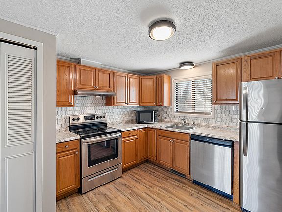 Large kitchen with dishwasher and room for a table.