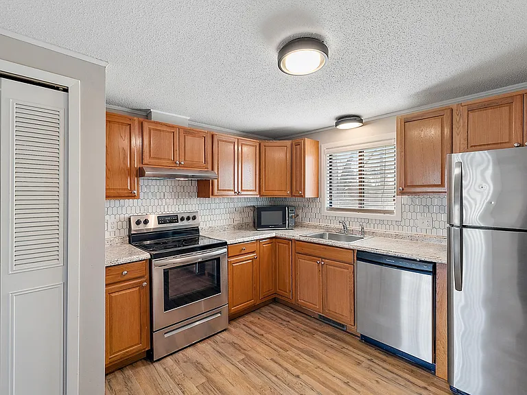 Large kitchen with dishwasher and room for a table.