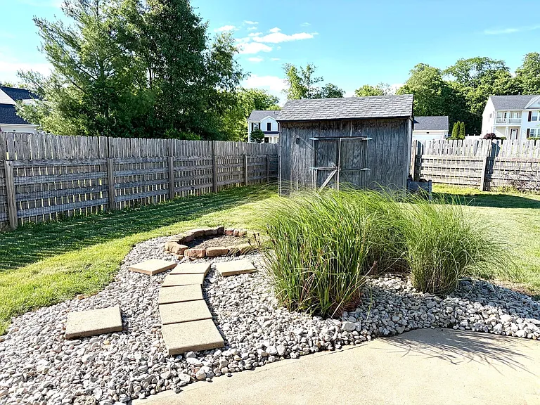Fully fenced rear yard with large concrete patio and fire-pit, for peaceful and pleasant evening at home