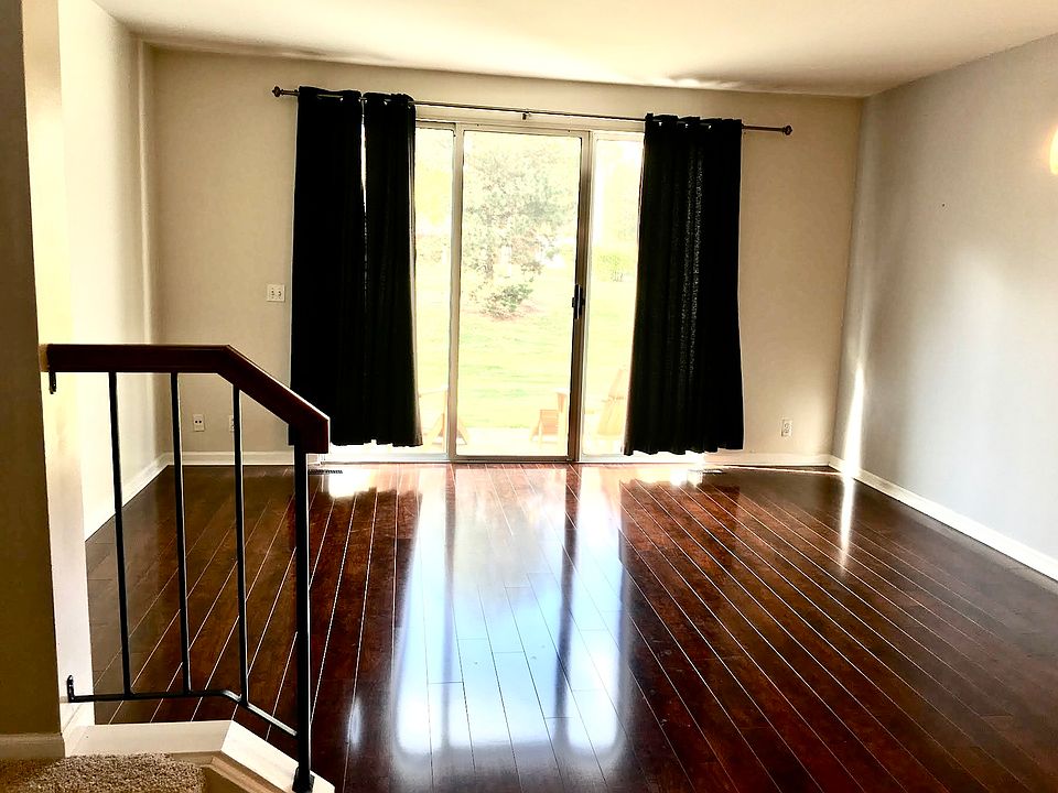 large combo living and dining room with flooring upgrade and sliding doors leading out to a cute patio