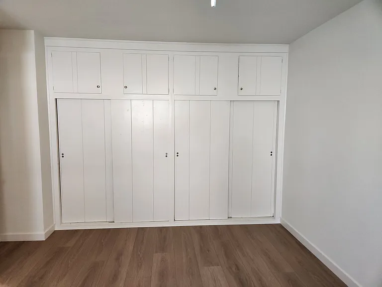 Large Wall-to-Wall Closet and upper cabinet area