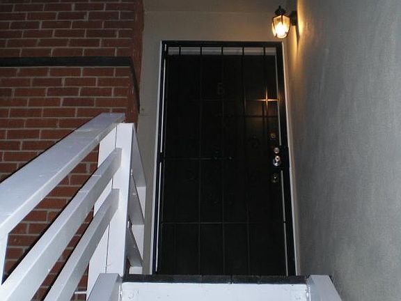 Entry to this unit from courtyard. motion sensor light and screen door