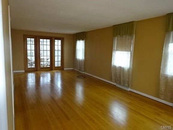 Look at the hardwood floors! Living room leads to enclosed porch!