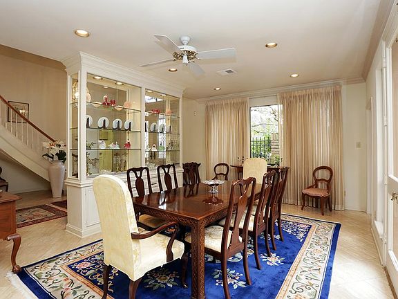 Formal Dining
The marble tile and crown molding continues into the Formal Dining room. Separated by a custom built-in display cabinet, this space has an open feel while still offering some separation.