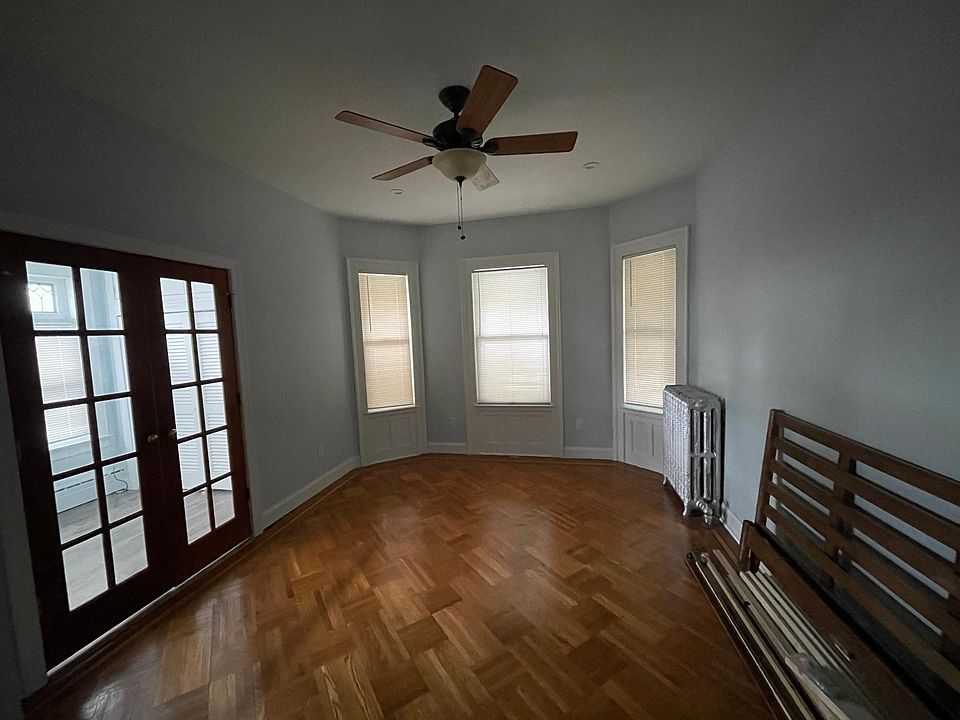 Large bedroom with sliding door closet and storage space above.