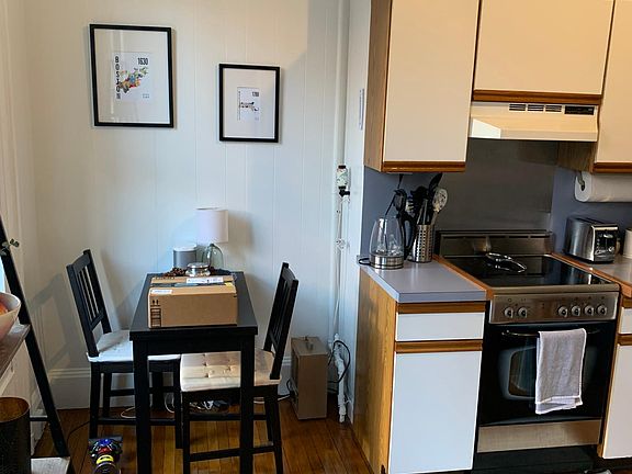 Spacious eat in kitchen with newer oven range, private deck off of the kitchen on left.