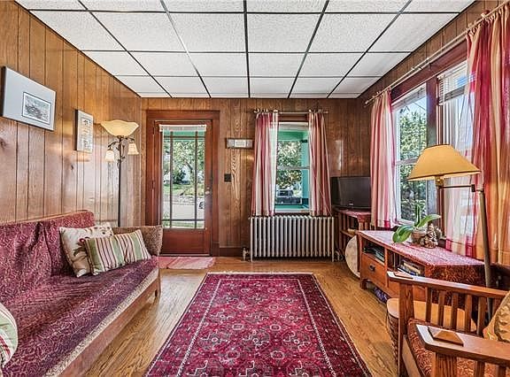 This bright and sunny living room is a bright and cheerful entrance to the home, and leads out to the front porch.