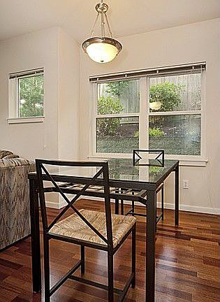 Dining area with wood floors and large window. Very private...no neighbors!