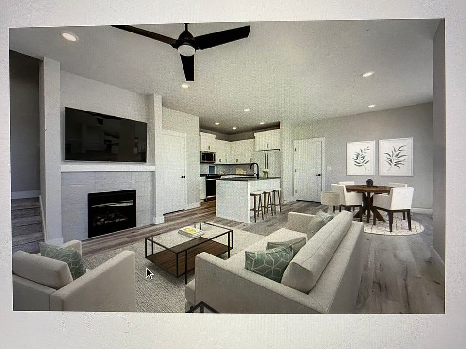 Paisley model, as if furnished. Open floor plan first floor; this home for rent also has white walls, cabinets, and countertops. And light tan plank floor