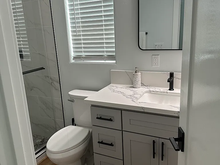 Hall bathroom with walk in showers.