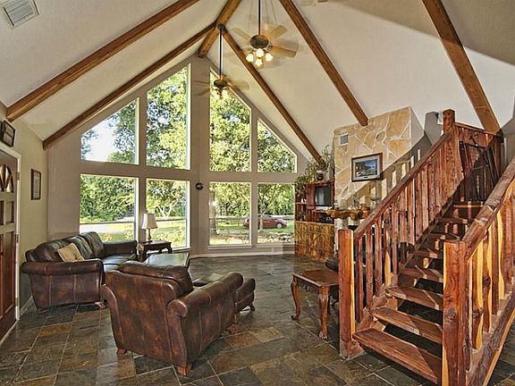 The large den has a huge wall of windows that flood the room with natural light.