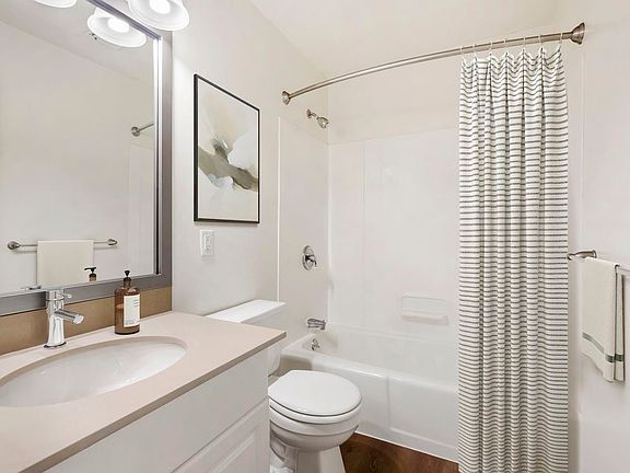 Renovated Package III bath with grey quartz countertops, white or cherry cabinetry, and hard surface flooring