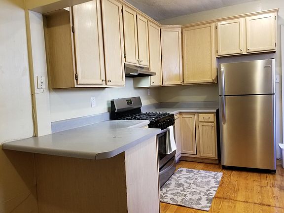 Kitchen has tons of cabinets and a counter for 2 bar stools