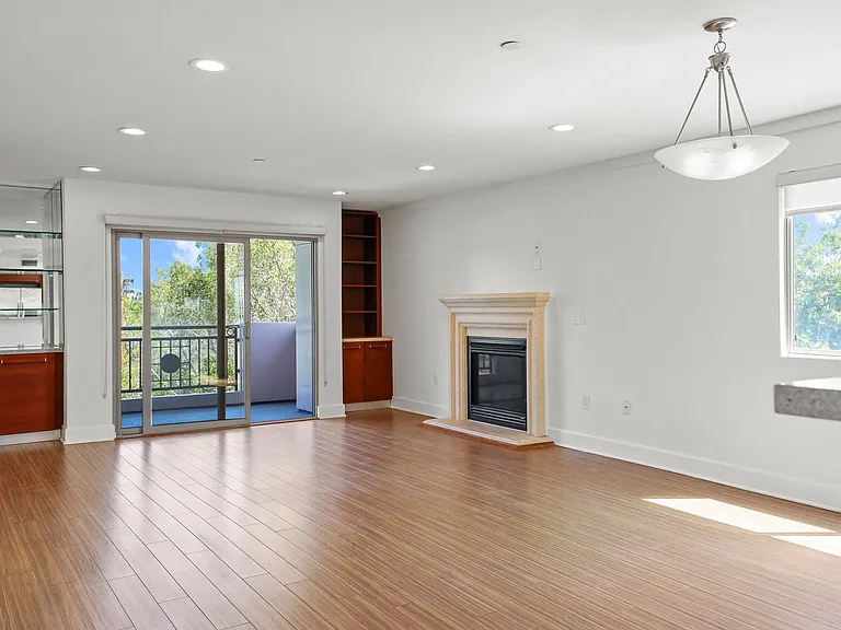 Living Room with Built-In Shelving, Patio, and Fireplace