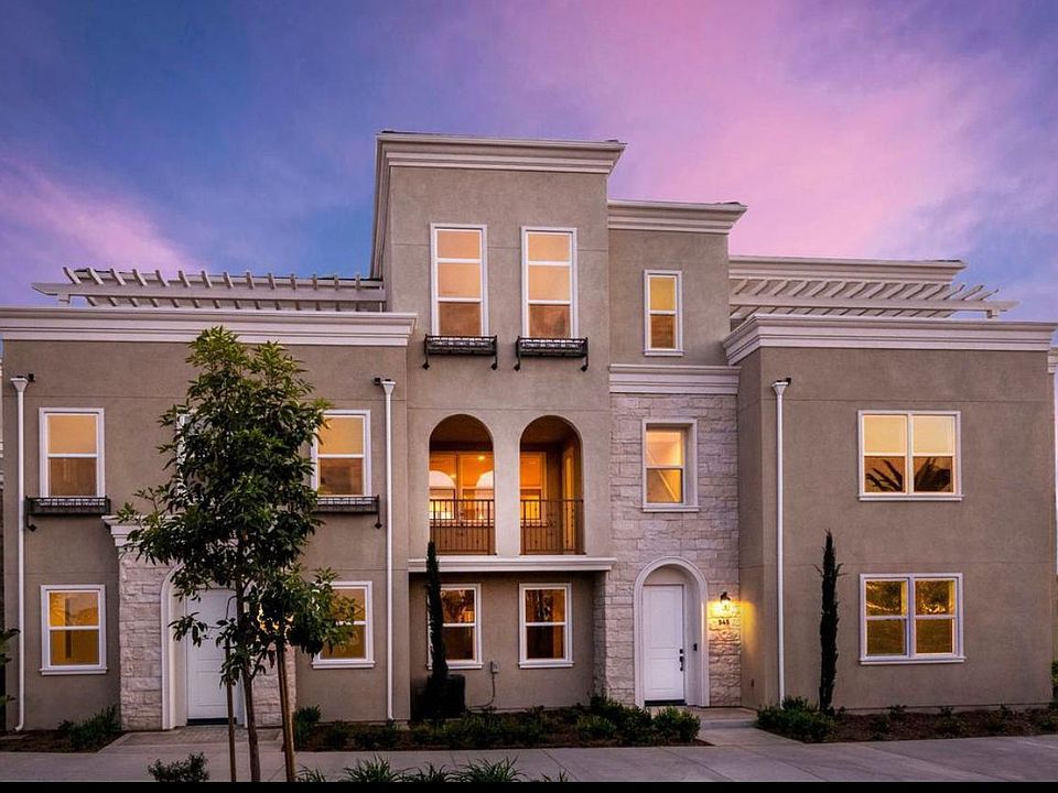 Three story townhouse with a rooftop patio.