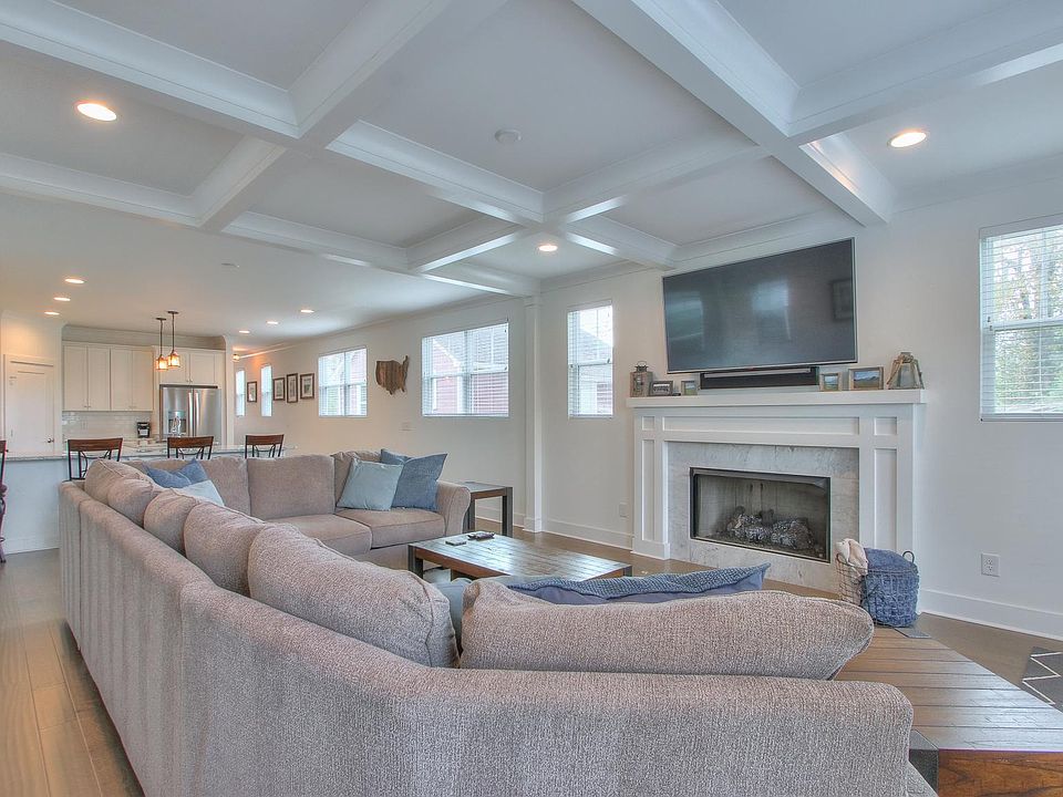 Open living room with remote controlled, gas fireplace. Oversized couch pictured.