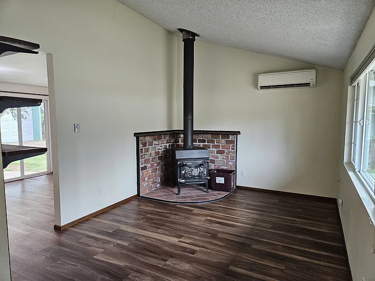Main floor living room looking S at wood stove and ductless heat pump.