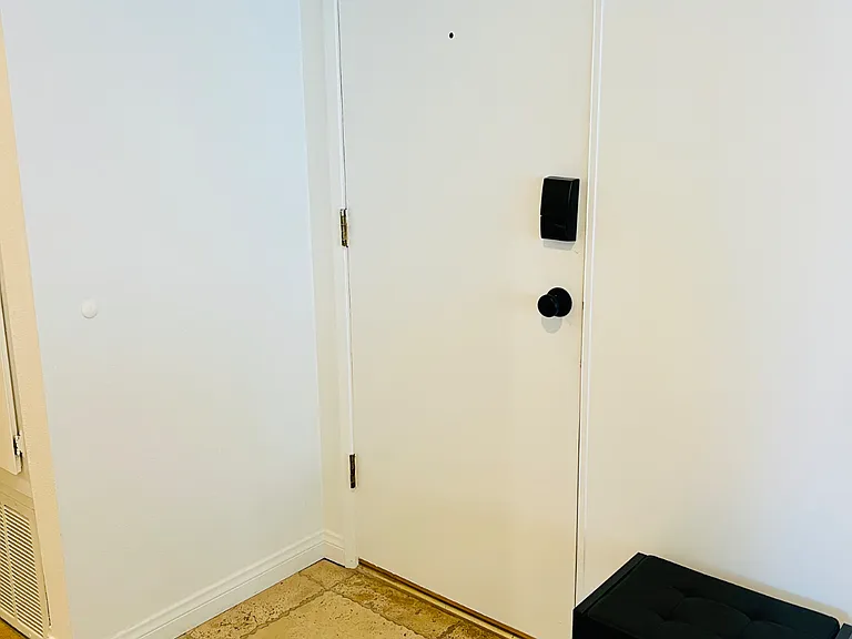 This is just inside the condo unit's front door--shoe bench and hooks for bags and stuff
