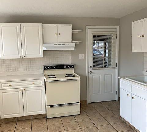 Door opens directly into the carport.