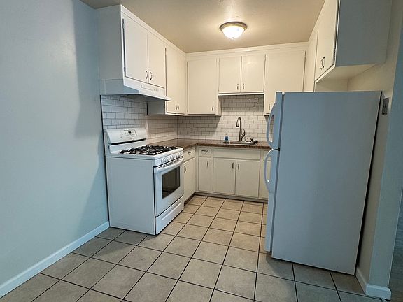 2br kitchen with white subway tiles, unfurnished