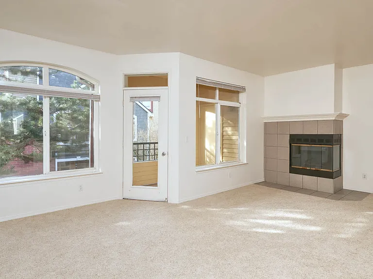 Carpeted Living Room with Fireplace