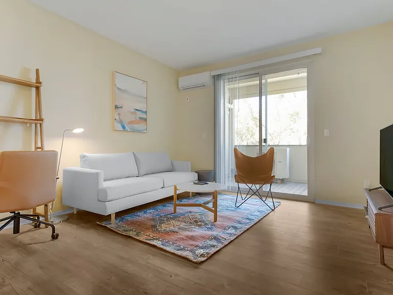 Furnished+ apartment homes come outfitted with a sofa, side chair, side table, coffee table, TV stand and 50" Television (Representative Image exact items and style of furnishings may vary)