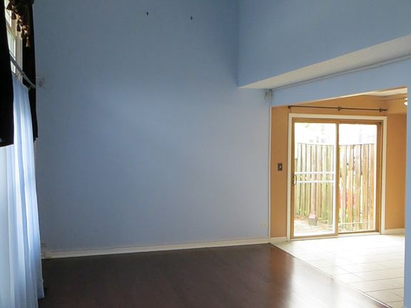 Living room with vaulted ceiling and pre-finished hardwood floor