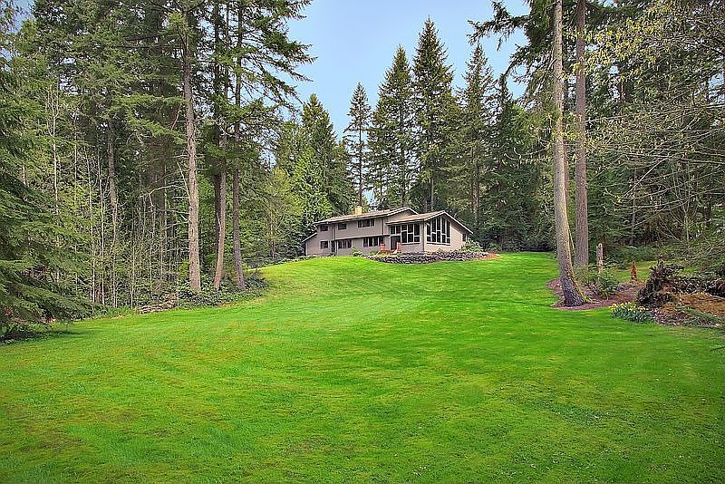 Expansive green space set amongst mature evergreens.