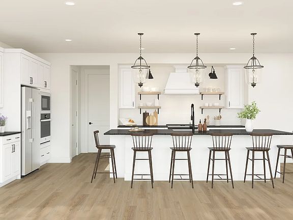 Kitchen with white cabinetry pendant lights