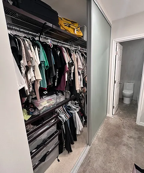 Custom master closet with drawers, bars and shelves. Exterior panels are frosted glass. Left side