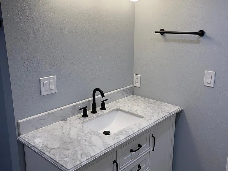 Marble topped bath vanity with soft close drawers and plenty of light