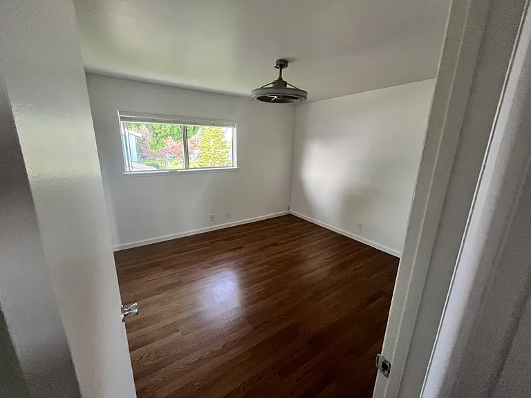 Primary bedroom, 2 mirrored closets, great window with view, ceiling fan/light, nice white paint